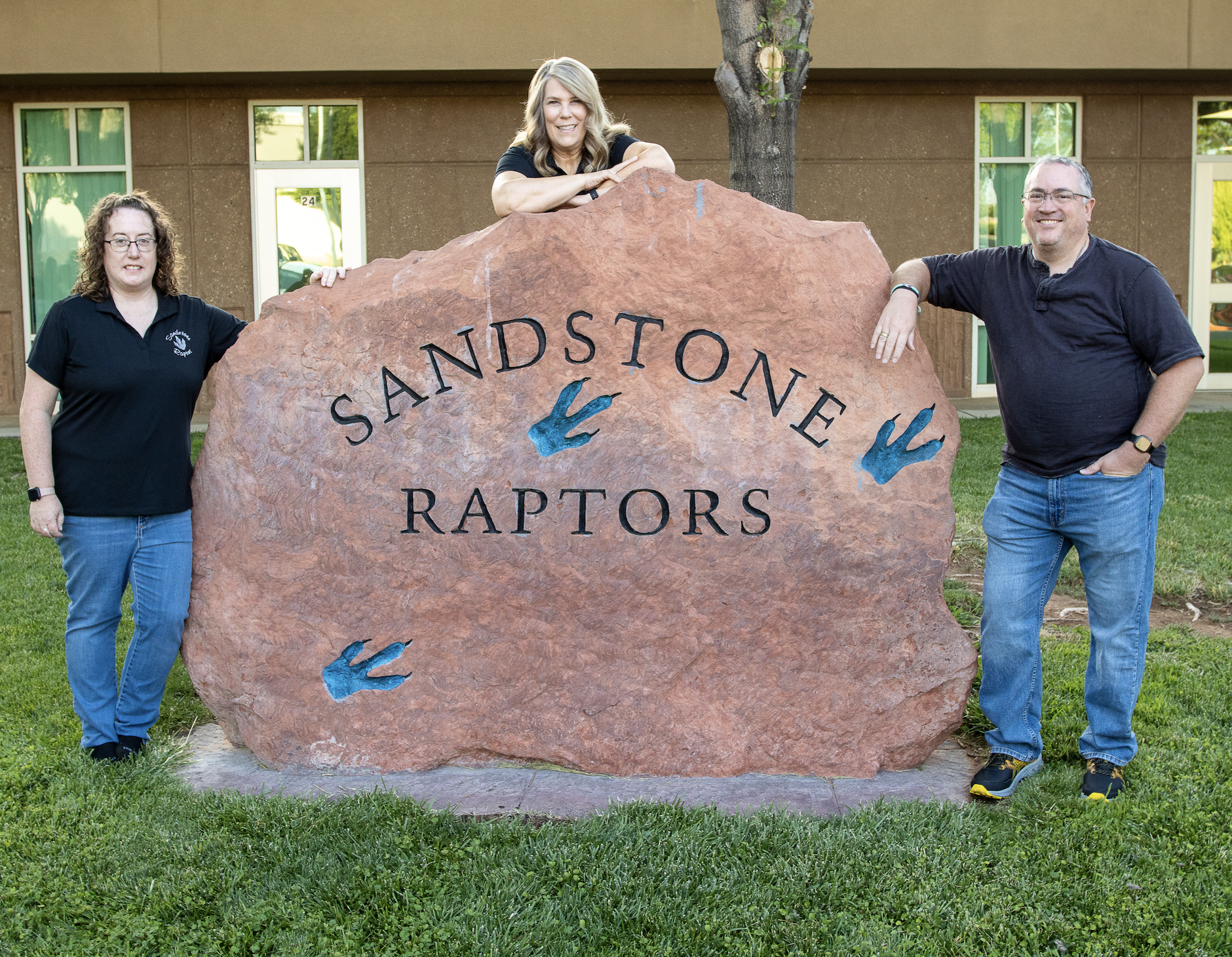 Three fifth grade teachers standing near the Sandstone Rock.